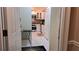 View from the hallway into the kitchen featuring white cabinets, tile floors and backsplash, and stainless steel appliances at 3275 Lenox Ne Rd # 110, Atlanta, GA 30324