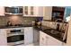 Updated kitchen with stainless steel appliances, granite countertops, and gas range at 3275 Lenox Ne Rd # 110, Atlanta, GA 30324