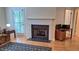 Bright living room featuring a fireplace, hardwood floors, and access to outdoor patio at 3275 Lenox Ne Rd # 110, Atlanta, GA 30324