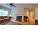 Comfortable living room featuring a fireplace, hardwood floors and a ceiling fan at 3275 Lenox Ne Rd # 110, Atlanta, GA 30324