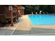 Community pool featuring lounge chairs, umbrellas, and a seating area by the pool at 3275 Lenox Ne Rd # 110, Atlanta, GA 30324