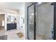 Bright bathroom features a walk-in shower with glass door, soaking tub and double vanity with dark cabinets and white countertop at 466 Sweet Apple Ln, Buford, GA 30518