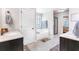 Bright bathroom features a walk-in shower with glass door, soaking tub and double vanity with dark cabinets and white countertop at 466 Sweet Apple Ln, Buford, GA 30518