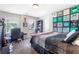 Bedroom featuring a bed, office area, and view of exterior through large windows at 466 Sweet Apple Ln, Buford, GA 30518