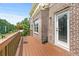 Deck showcasing brick facade, trimmed windows, wood railing and seasonal greenery at 466 Sweet Apple Ln, Buford, GA 30518