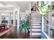Elegant foyer with hardwood floors and staircase, leading to open-concept living spaces at 466 Sweet Apple Ln, Buford, GA 30518