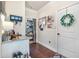 Hallway with hardwood floors, a storage nook, and a white front door with seasonal wreath at 466 Sweet Apple Ln, Buford, GA 30518