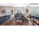 Kitchen with island, dining area, modern appliances, and hardwood floors at 466 Sweet Apple Ln, Buford, GA 30518
