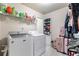 Laundry room with washer, dryer, shelves, and luggage for all your laundry needs at 466 Sweet Apple Ln, Buford, GA 30518