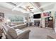 Cozy living room with a fireplace, coffered ceilings, and comfortable seating at 466 Sweet Apple Ln, Buford, GA 30518