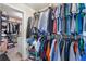 Walk-in closet with clothing racks installed along the walls and plenty of storage space and access to another walk-in closet at 466 Sweet Apple Ln, Buford, GA 30518