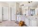 Bright bathroom featuring a double vanity with white cabinets and a large mirror at 4854 Cathedral Ct, Powder Springs, GA 30127