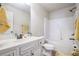 Well-lit bathroom with a white vanity, a bathtub-shower combo, and a yellow hand towel at 4854 Cathedral Ct, Powder Springs, GA 30127
