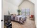 Cozy bedroom with a vaulted ceiling, bright window and simple bed frame at 4854 Cathedral Ct, Powder Springs, GA 30127