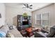Inviting living room offering a comfortable sofa, ceiling fan, and a large window at 4854 Cathedral Ct, Powder Springs, GA 30127