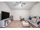 Spacious living room featuring comfortable seating and a large television, perfect for relaxing at 4854 Cathedral Ct, Powder Springs, GA 30127