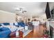 Comfortable living room with hardwood floors, ceiling fan, and a view of the kitchen at 4854 Cathedral Ct, Powder Springs, GA 30127