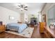 Spacious main bedroom suite boasts hardwood floors, a ceiling fan, and sunny windows at 4854 Cathedral Ct, Powder Springs, GA 30127