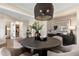 Stylish dining area featuring a modern light fixture, round table, and tasteful wall art at 5430 Hyde Rd, Cumming, GA 30040