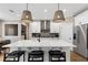 Modern kitchen with white cabinets, stainless steel appliances, a large island, and stylish pendant lighting at 5430 Hyde Rd, Cumming, GA 30040