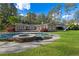 A backyard features a swimming pool with a hot tub and a well-manicured lawn at 860 Crest Valley Dr, Sandy Springs, GA 30327