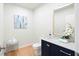 Stylish half bathroom featuring modern fixtures, elegant mirror, and sophisticated color palette at 860 Crest Valley Dr, Sandy Springs, GA 30327