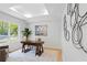 Bright office space with large window, modern art, and a stylish desk, perfect for remote work at 860 Crest Valley Dr, Sandy Springs, GA 30327