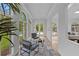 Bright sunroom with large windows offering stunning views of the backyard and pool area at 860 Crest Valley Dr, Sandy Springs, GA 30327