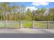 View of a private tennis court from a deck overlooking the court and surrounding trees at 860 Crest Valley Dr, Sandy Springs, GA 30327