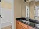 Bathroom featuring granite counters, vanity cabinet, tile floor, toilet, and tub at 125 Ancient Oak Ln, Stockbridge, GA 30281