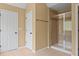 Bright bathroom featuring a glass-enclosed shower and neutral-toned tile flooring at 125 Ancient Oak Ln, Stockbridge, GA 30281