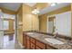 Bathroom featuring dual sinks with granite countertops and a large mirror above the vanity at 125 Ancient Oak Ln, Stockbridge, GA 30281