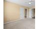 Spacious bedroom with carpet and neutral walls with a doorway to the ensuite at 125 Ancient Oak Ln, Stockbridge, GA 30281