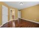 Bedroom featuring hardwood floors and neutral walls with doors to the hallway and bathroom at 125 Ancient Oak Ln, Stockbridge, GA 30281