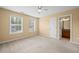 Bright bedroom featuring carpet, a ceiling fan, and an ensuite bathroom at 125 Ancient Oak Ln, Stockbridge, GA 30281