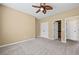 Neutral bedroom featuring doors leading to a closet and bath at 125 Ancient Oak Ln, Stockbridge, GA 30281