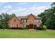 Charming two-story brick home with a well-manicured lawn and mature landscaping at 125 Ancient Oak Ln, Stockbridge, GA 30281