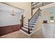 Inviting foyer featuring a staircase with iron balusters and hardwood floors, with a dining room to the left at 125 Ancient Oak Ln, Stockbridge, GA 30281