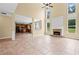 Open-concept living room flowing into the kitchen, featuring large windows and a fireplace at 125 Ancient Oak Ln, Stockbridge, GA 30281