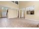 Spacious living room with a two-story ceiling, tile flooring, and natural light at 125 Ancient Oak Ln, Stockbridge, GA 30281