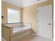 Main bathroom featuring a jetted tub, and a neutral color palette at 125 Ancient Oak Ln, Stockbridge, GA 30281