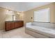 Main bathroom featuring a double vanity, and jetted tub at 125 Ancient Oak Ln, Stockbridge, GA 30281