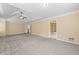Spacious main bedroom featuring a tray ceiling, and doorways to other rooms at 125 Ancient Oak Ln, Stockbridge, GA 30281