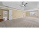 Spacious main bedroom featuring tray ceiling, and doorways to other rooms at 125 Ancient Oak Ln, Stockbridge, GA 30281
