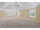 Spacious main bedroom featuring windows with blinds, neutral carpet, and tray ceiling at 125 Ancient Oak Ln, Stockbridge, GA 30281
