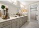 Bright primary bathroom featuring marble countertops, dual sinks, and elegant lighting at 131 Forsyth Park Ln, Woodstock, GA 30188