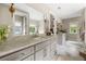 Bright bathroom with marble floors, double vanity, and elegant fixtures and decor at 131 Forsyth Park Ln, Woodstock, GA 30188