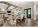 Open dining and living area with hardwood floors, fireplace, and natural light, perfect for entertaining and relaxation at 131 Forsyth Park Ln, Woodstock, GA 30188