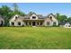 Exterior of beautiful, modern home with pristine lawn and manicured landscaping at 131 Forsyth Park Ln, Woodstock, GA 30188