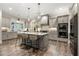 Modern kitchen with a large island and stainless steel appliances at 131 Forsyth Park Ln, Woodstock, GA 30188